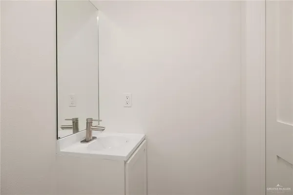 a bathroom with a sink a shower and a mirror