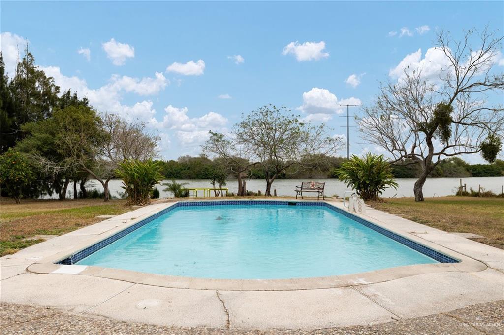 34732 Kretz Road, Unit 2 Los Fresnos, TX 78566 - Photo 15 of 22 a view of a swimming pool with an outdoor seating and a yard