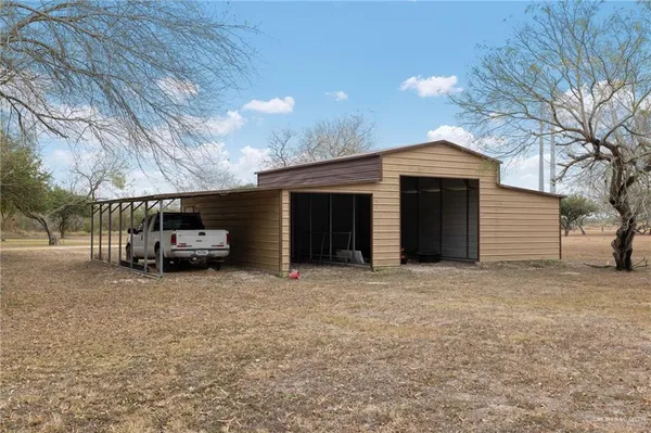a front view of house with a garden and patio