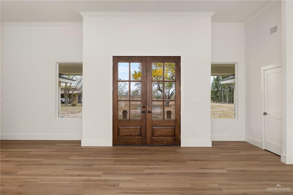 34732 Kretz Road, Unit 2 Los Fresnos, TX 78566 - Photo 3 of 22 a view of a big room with wooden floor and windows