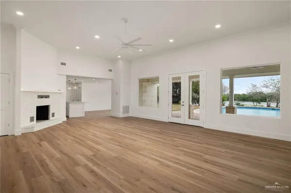 a view of a livingroom with wooden floor and a fireplace