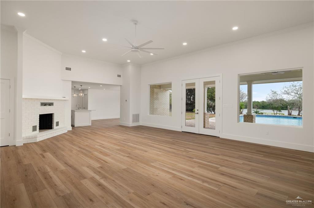 34732 Kretz Road, Unit 2 Los Fresnos, TX 78566 - Photo 6 of 22 a view of a livingroom with wooden floor and a fireplace