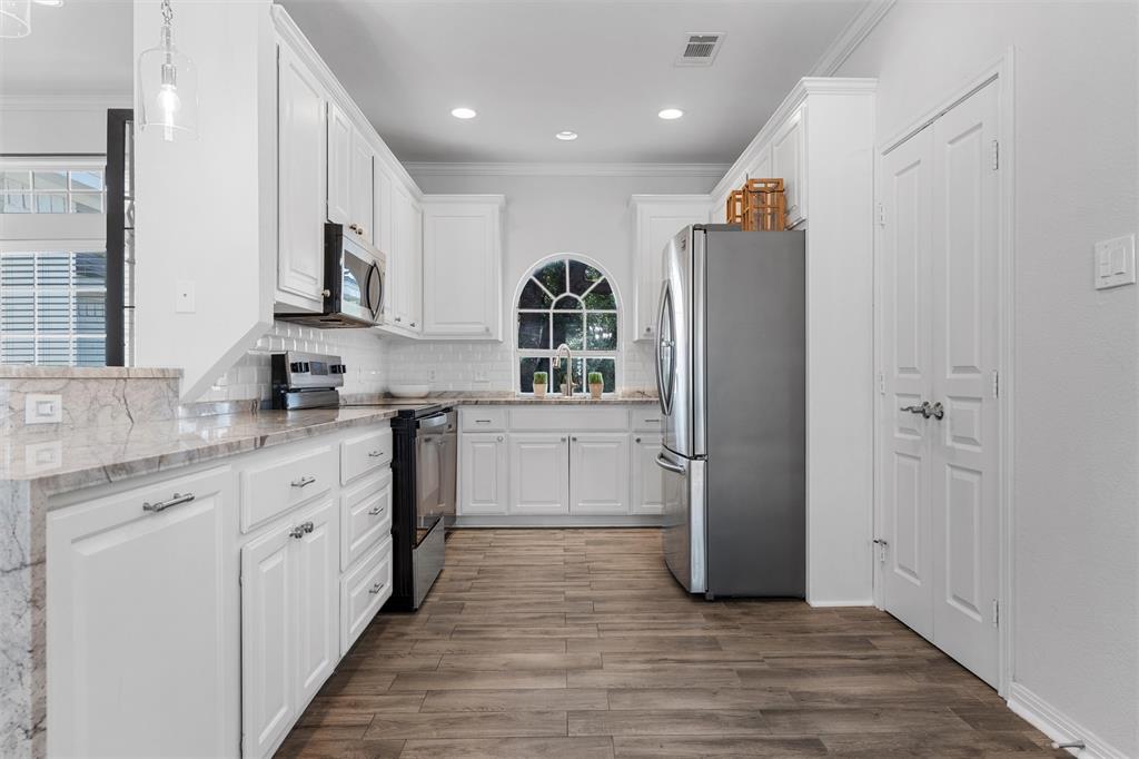 11209 Tree Lake Drive Waco, TX 76708 - Photo 11 of 40 a kitchen with stainless steel appliances granite countertop a refrigerator and a stove top oven
