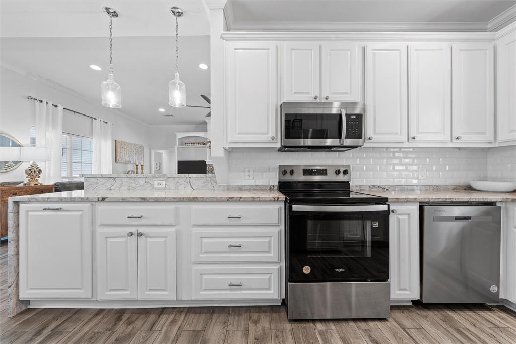 11209 Tree Lake Drive Waco, TX 76708 - Photo 12 of 40 a kitchen with stainless steel appliances granite countertop a stove and a microwave