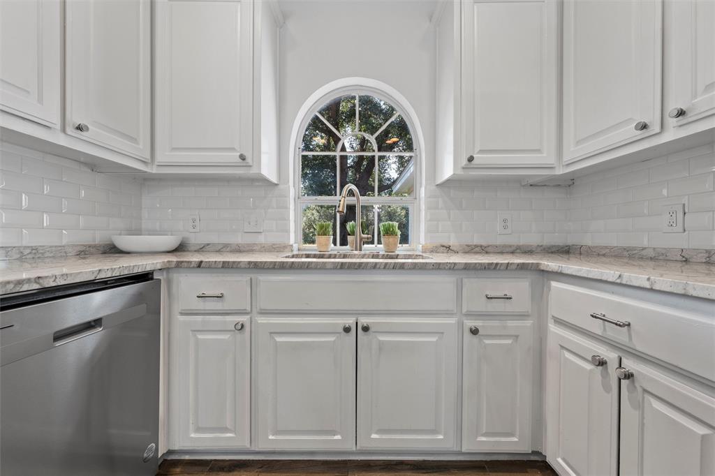 11209 Tree Lake Drive Waco, TX 76708 - Photo 13 of 40 a kitchen with granite countertop white cabinets and a sink