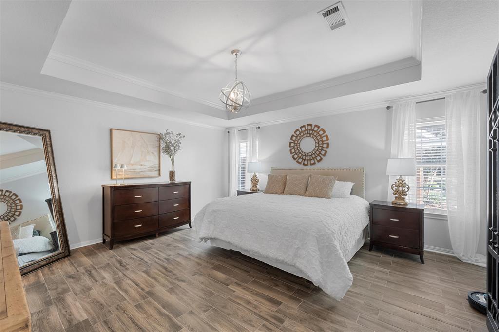 11209 Tree Lake Drive Waco, TX 76708 - Photo 16 of 40 a bedroom with a bed and a chandelier