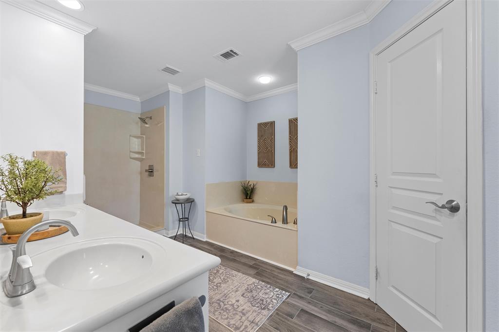 11209 Tree Lake Drive Waco, TX 76708 - Photo 18 of 40 a bathroom with a sink a bathtub and a window