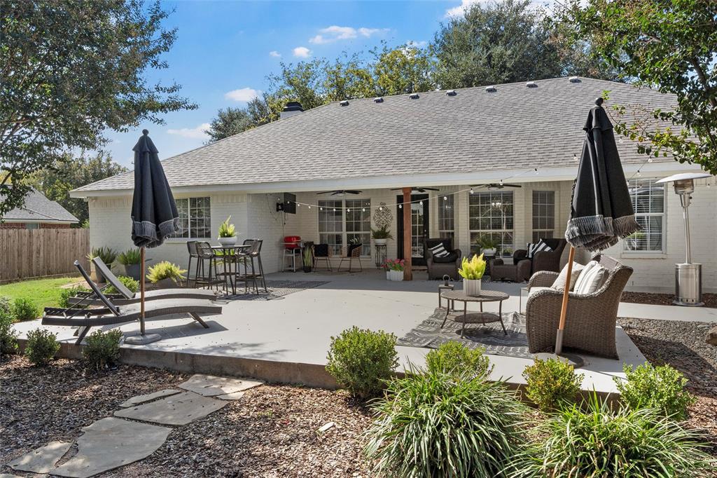 11209 Tree Lake Drive Waco, TX 76708 - Photo 25 of 40 a view of a patio with table and chairs potted plants and a large tree