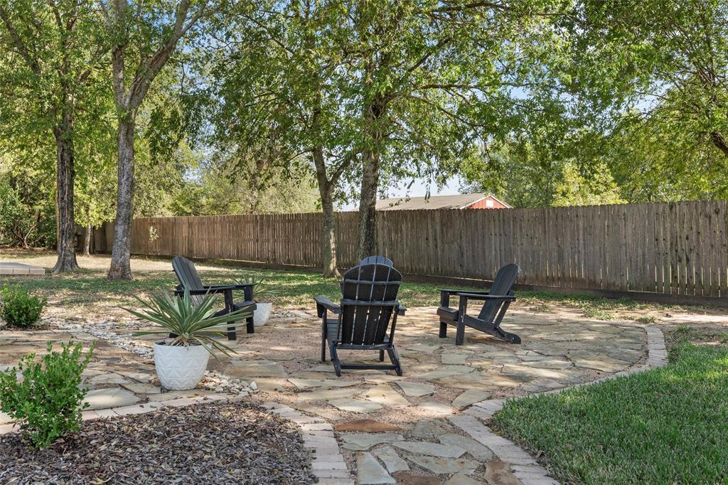 11209 Tree Lake Drive Waco, TX 76708 - Photo 28 of 40 a view of backyard with table and chairs potted plants and wooden fence