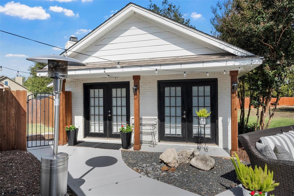 11209 Tree Lake Drive Waco, TX 76708 - Photo 33 of 40 a view of a patio with table and chairs potted plants and floor to ceiling window