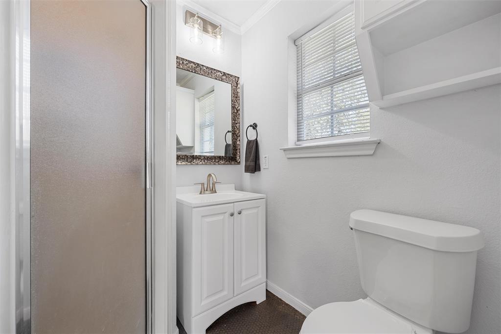 11209 Tree Lake Drive Waco, TX 76708 - Photo 37 of 40 a bathroom with a toilet a sink and mirror