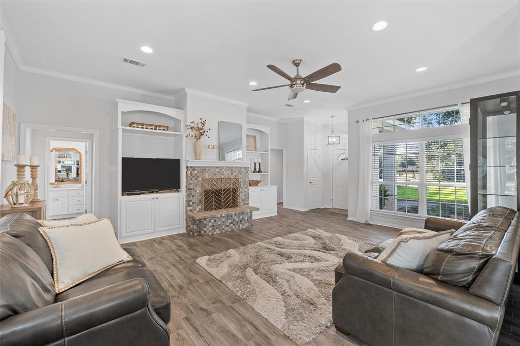 11209 Tree Lake Drive Waco, TX 76708 - Photo 6 of 40 a living room with furniture a fireplace and a flat screen tv