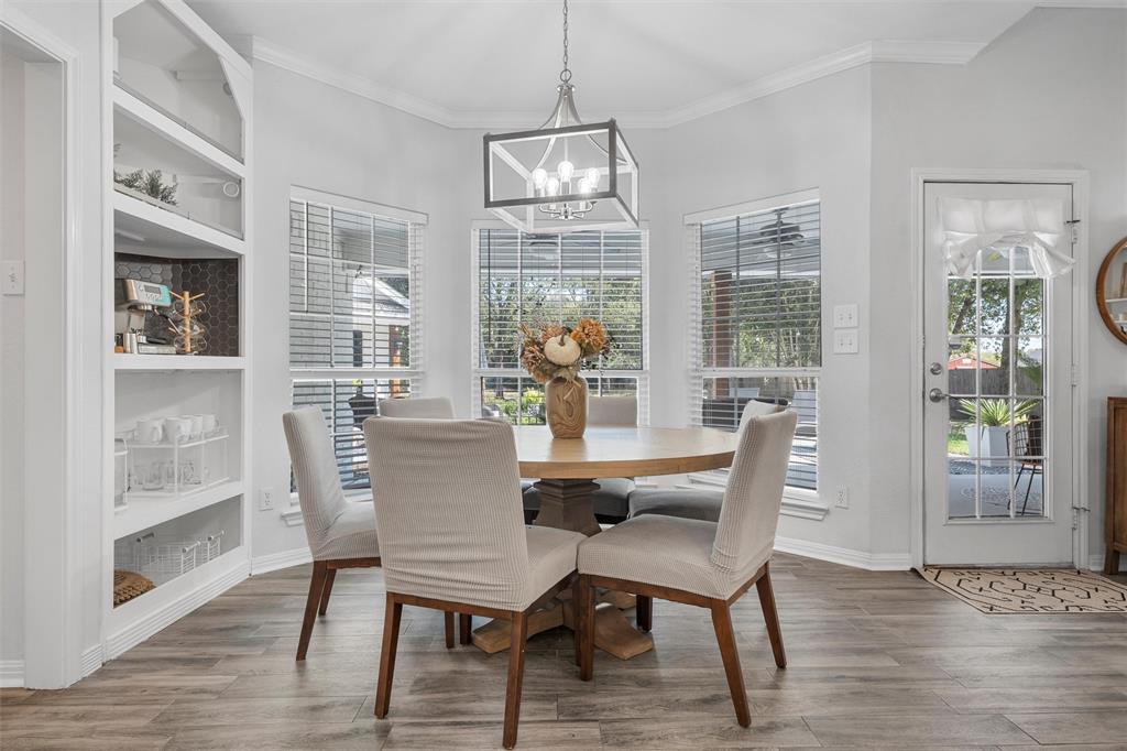 11209 Tree Lake Drive Waco, TX 76708 - Photo 10 of 40 a dining room with furniture wooden floor and a chandelier
