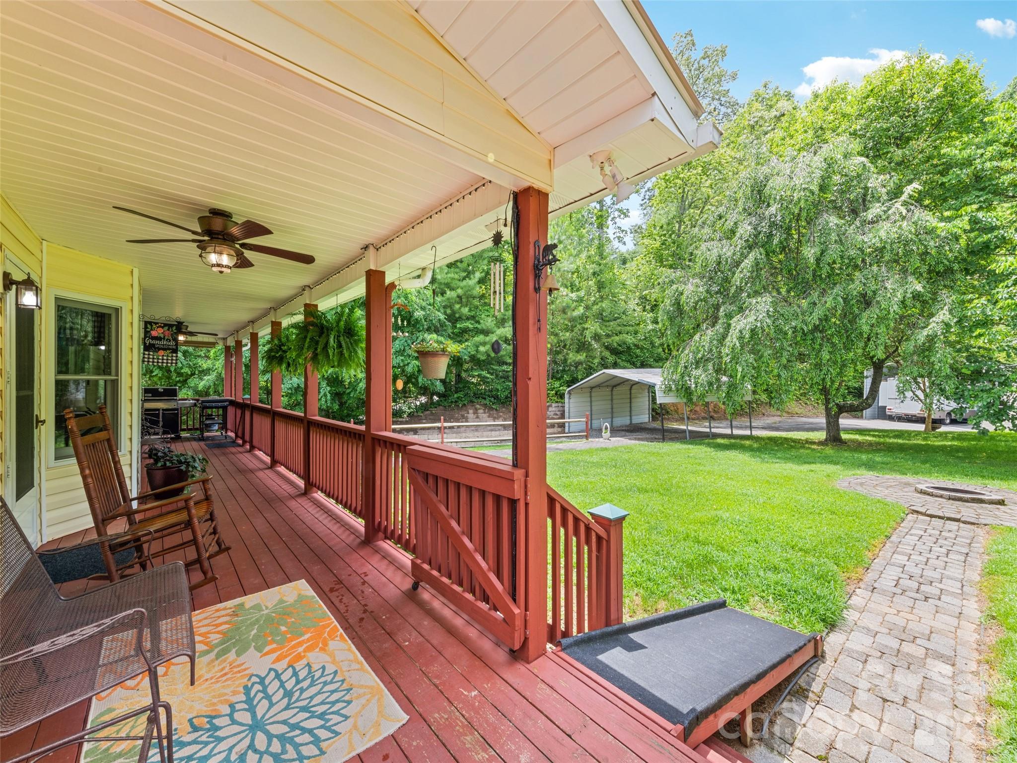 70 Lollis Lane Bryson City, NC 28713 - Photo 14 of 39 a view of a patio with a table chairs and a backyard