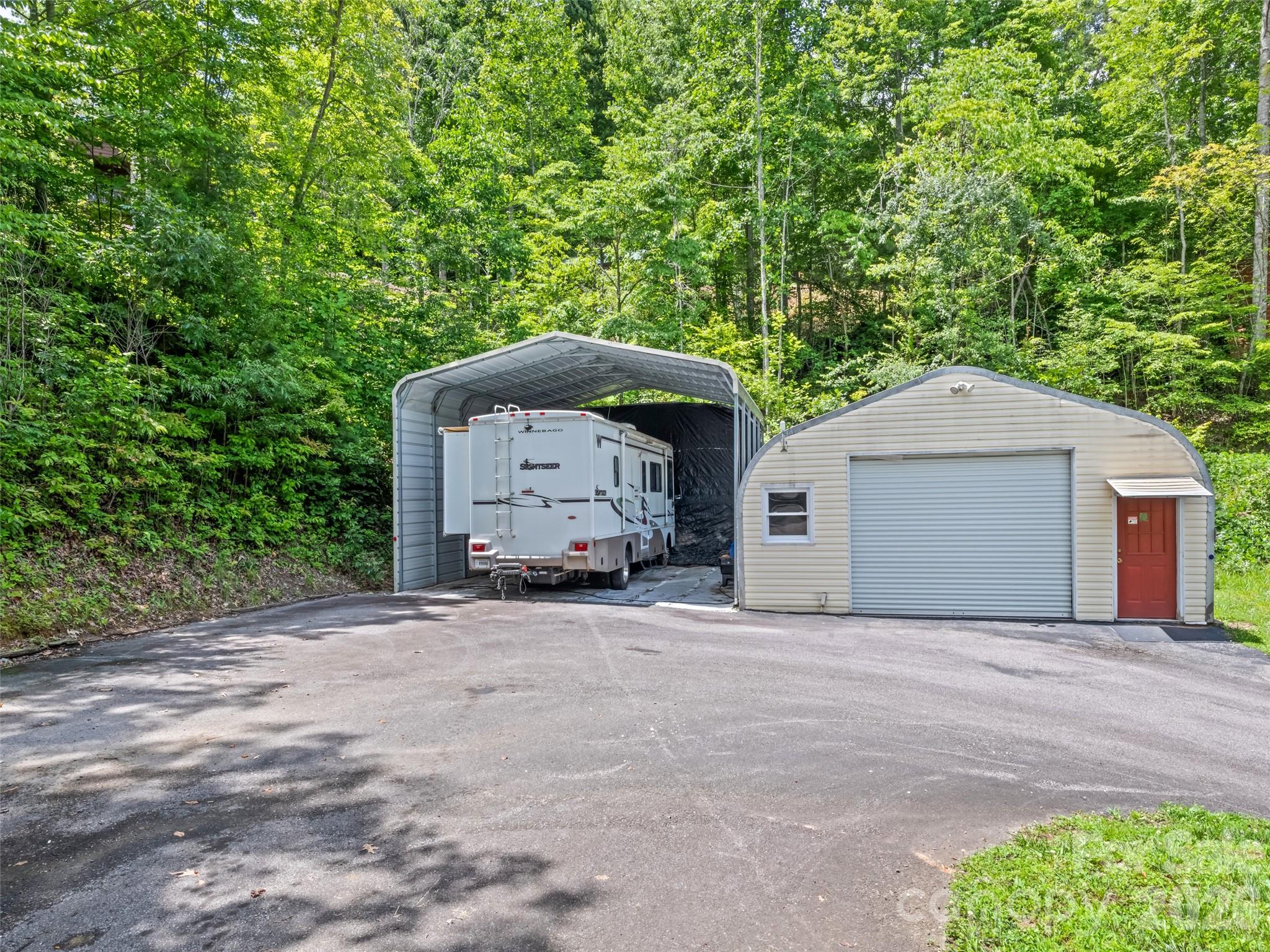 70 Lollis Lane Bryson City, NC 28713 - Photo 15 of 39 a front view of a house with a yard and garage