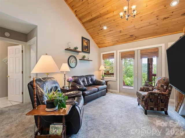 a living room with furniture a fireplace and a chandelier