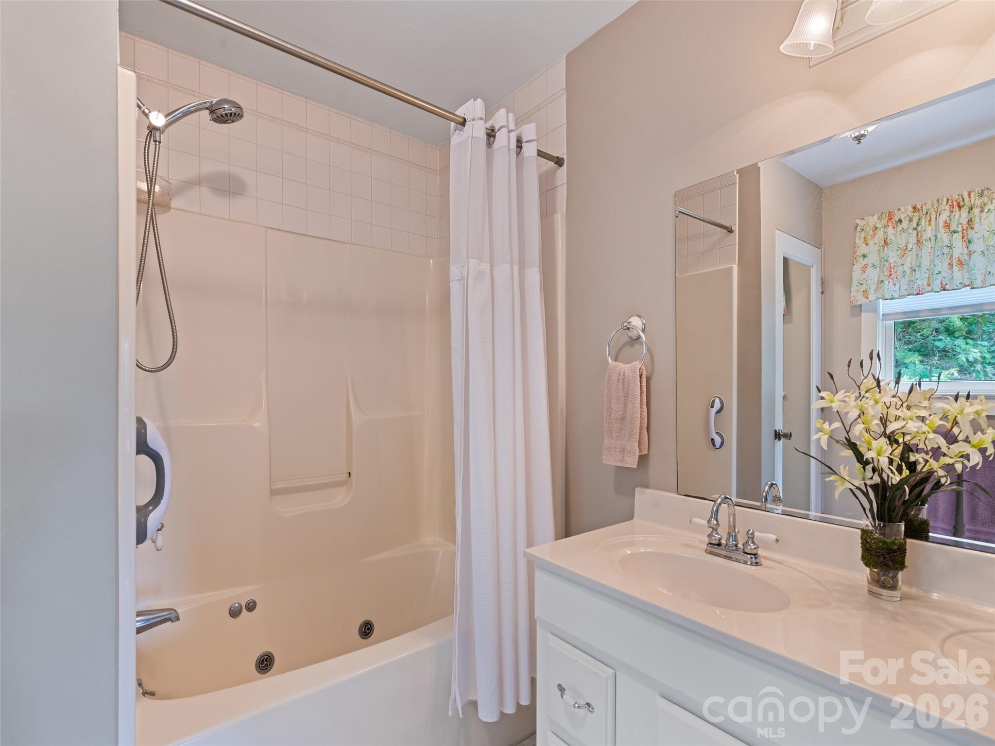 70 Lollis Lane Bryson City, NC 28713 - Photo 30 of 39 a bathroom with a tub shower vanity and a sink