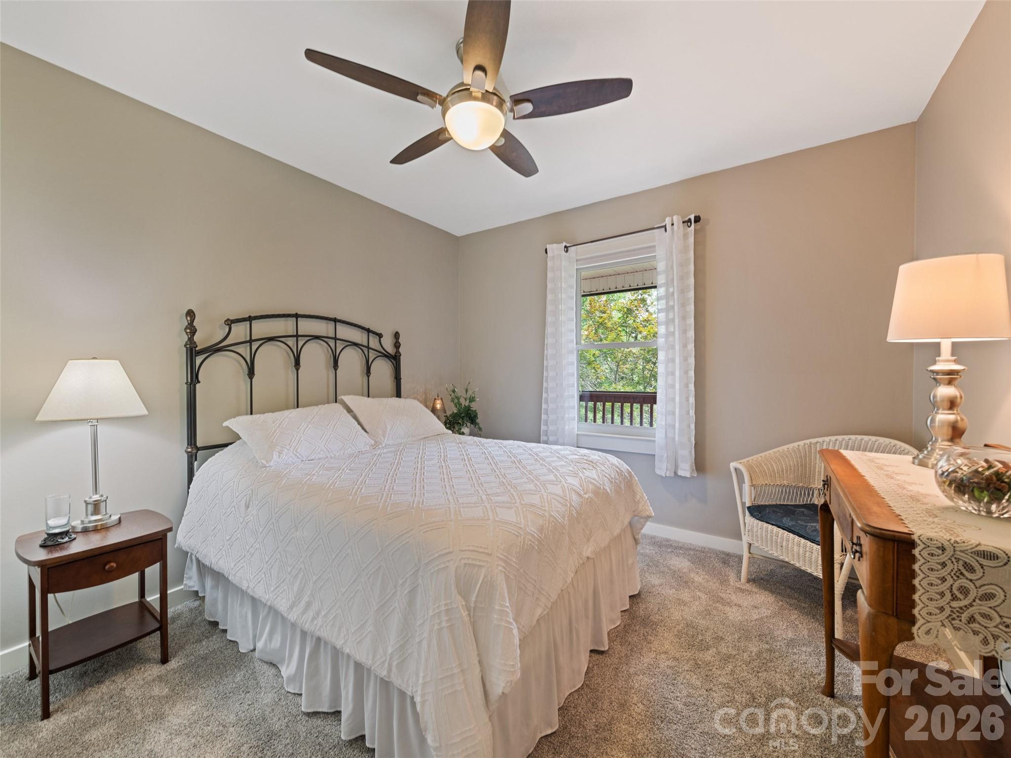 70 Lollis Lane Bryson City, NC 28713 - Photo 31 of 39 a bedroom with a bed and a lamp on dresser