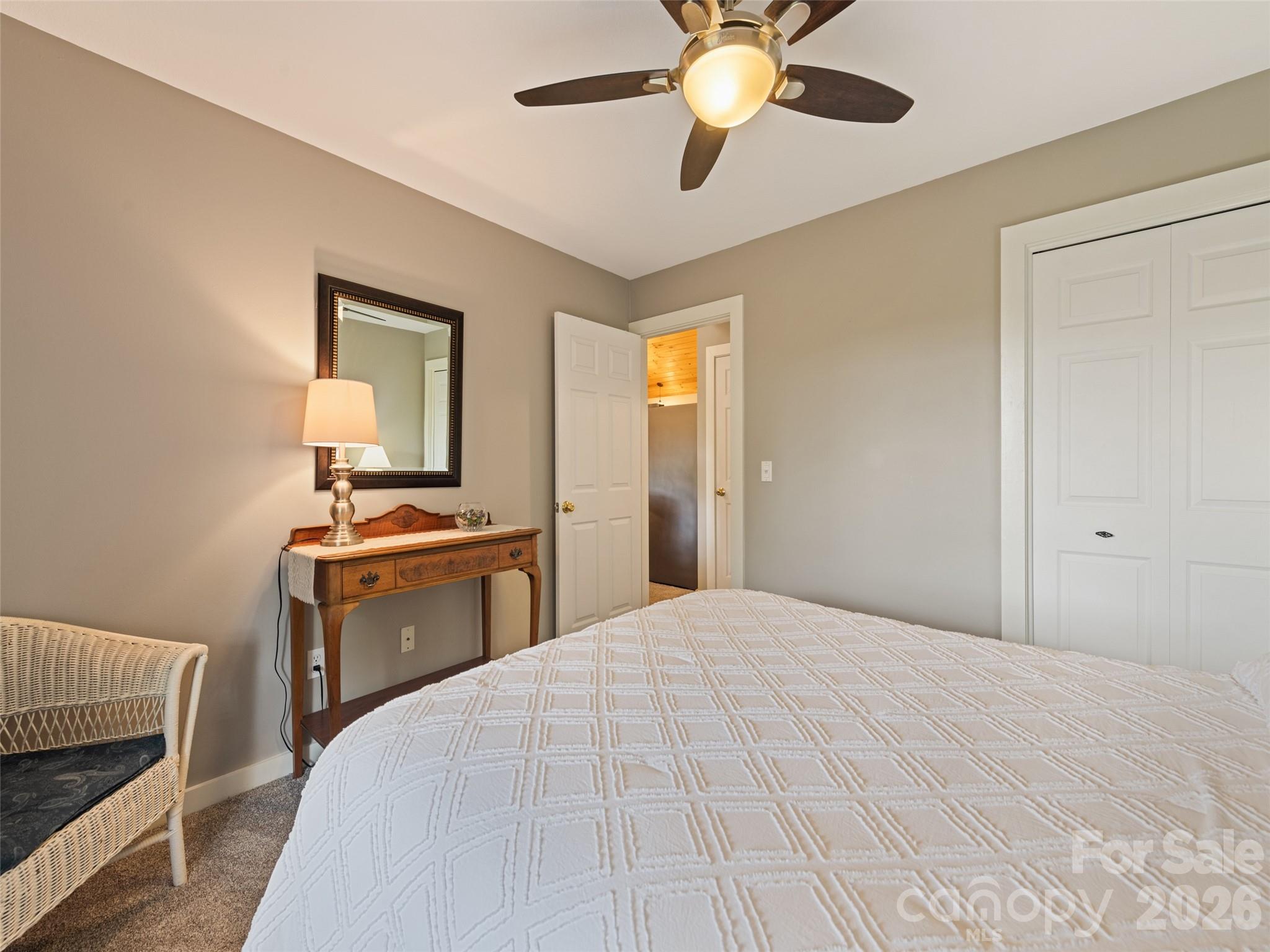 70 Lollis Lane Bryson City, NC 28713 - Photo 32 of 39 a bedroom with a bed and a chandelier