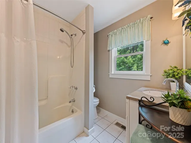 a bath room with a bath tub and a shower
