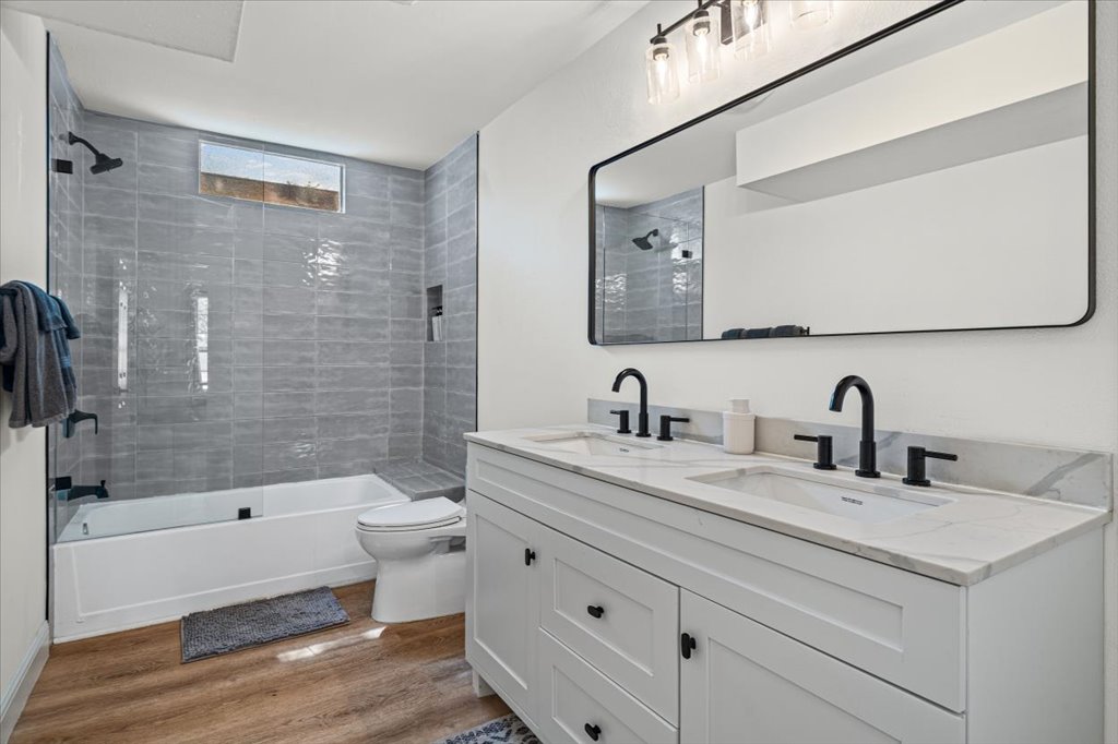 1201 Garden Street, Unit A Austin, TX 78702 - Photo 20 of 30 Modern bathroom featuring a dual vanity with white cabinetry and integrated sinks, matte black fixtures, and a large rectangular mirror