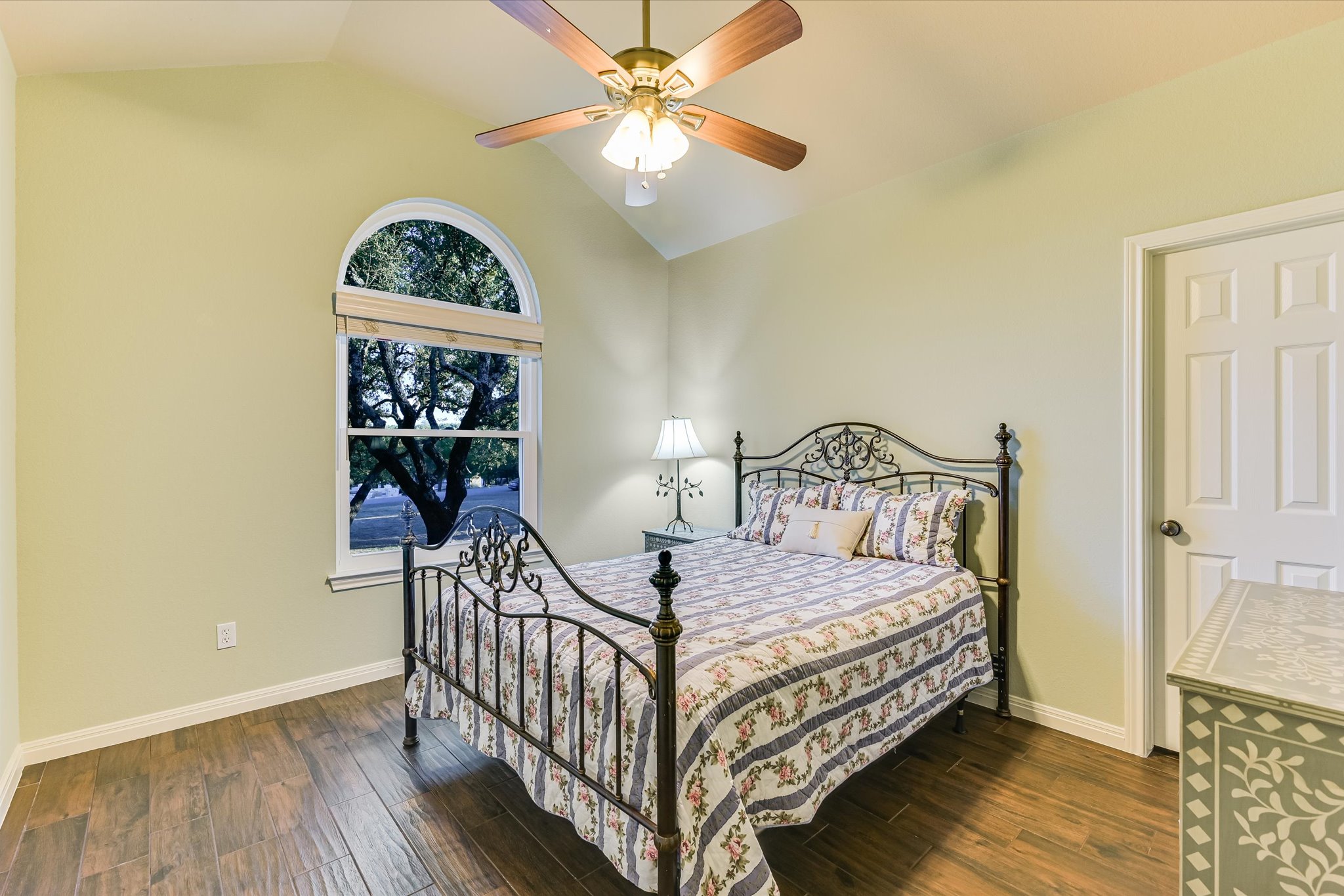 786 Ranchers Club Lane Driftwood, TX 78619 - Photo 24 of 33 Bedroom featuring vaulted ceiling, dark wood-style floors, and a ceiling fan