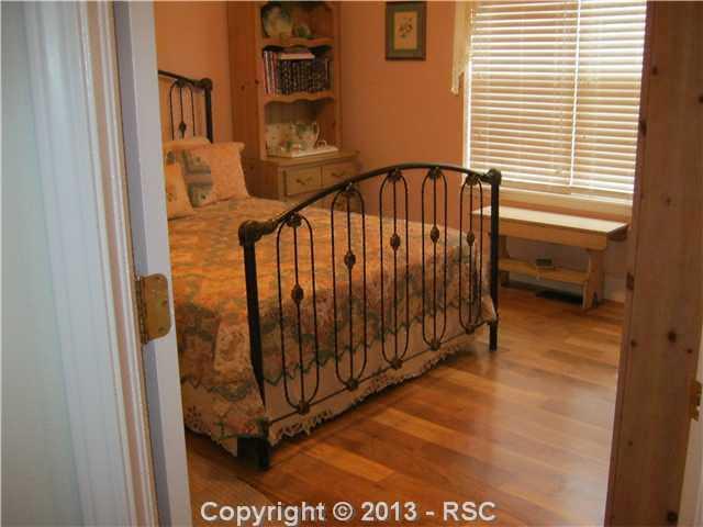 17425 Lodgepole Road Peyton, CO 80831 - Photo 10 of 20 Upper level secondary bedroom with hardwood floors
