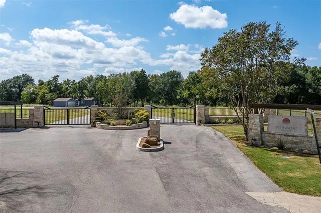 a wooden bench sitting in the middle of a yard
