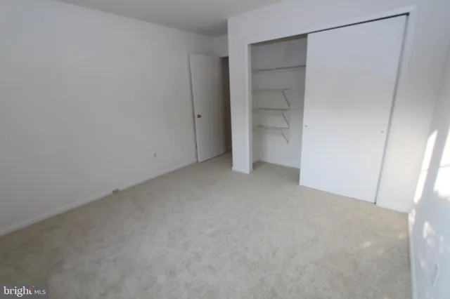 a view of empty room with closet