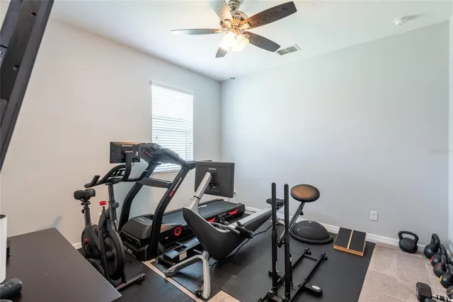a patio with table and chairs and potted plants