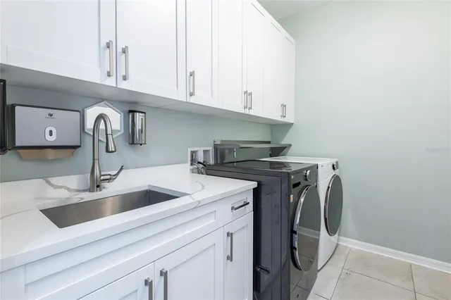 a view of a house with a yard and a tree