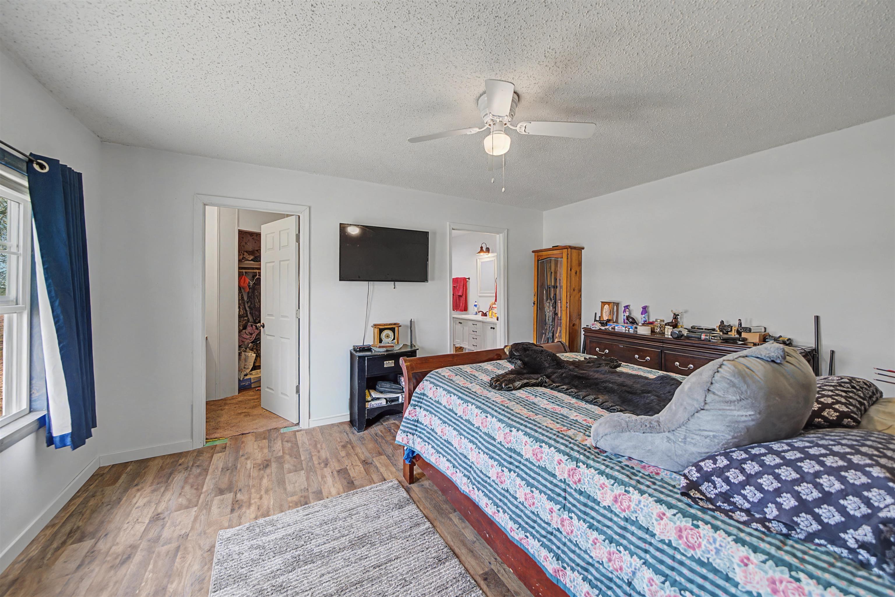 7010 22nd Highway Adamsville, TN 38310 - Photo 11 of 33 a bedroom with a bed and a flat screen tv