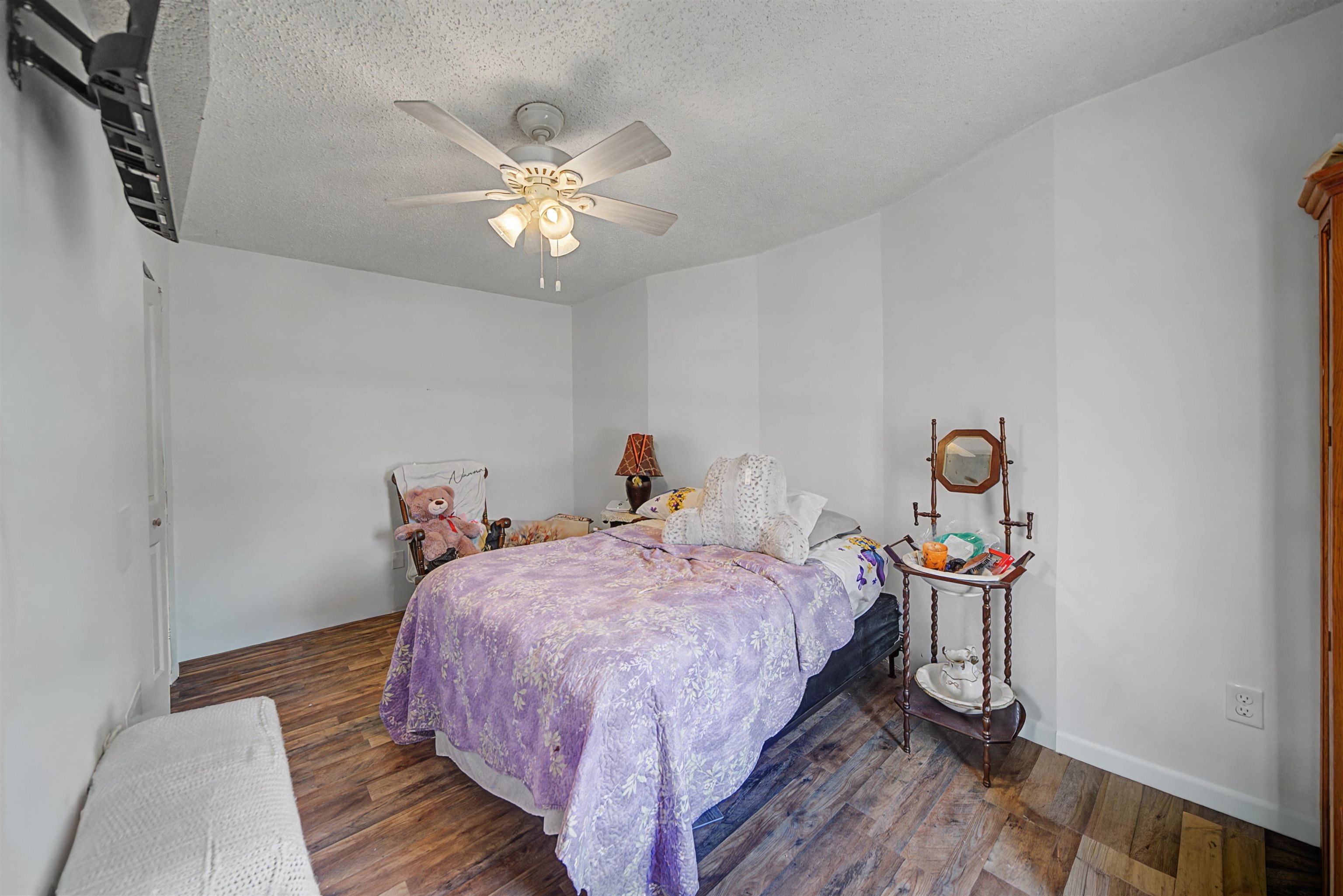 7010 22nd Highway Adamsville, TN 38310 - Photo 15 of 33 a bedroom with bed and a chandelier