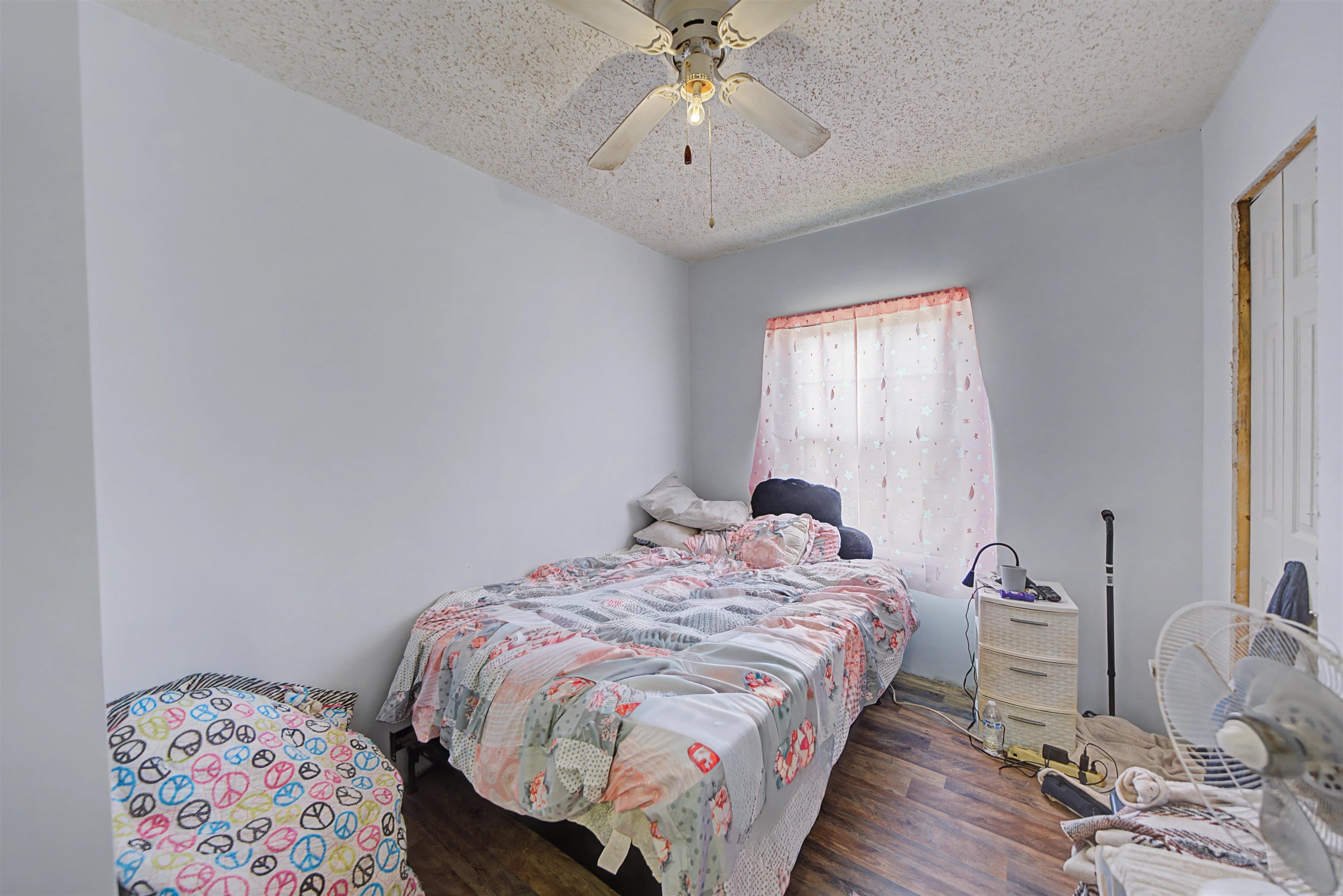 7010 22nd Highway Adamsville, TN 38310 - Photo 17 of 33 a bedroom with a bed and a chandelier