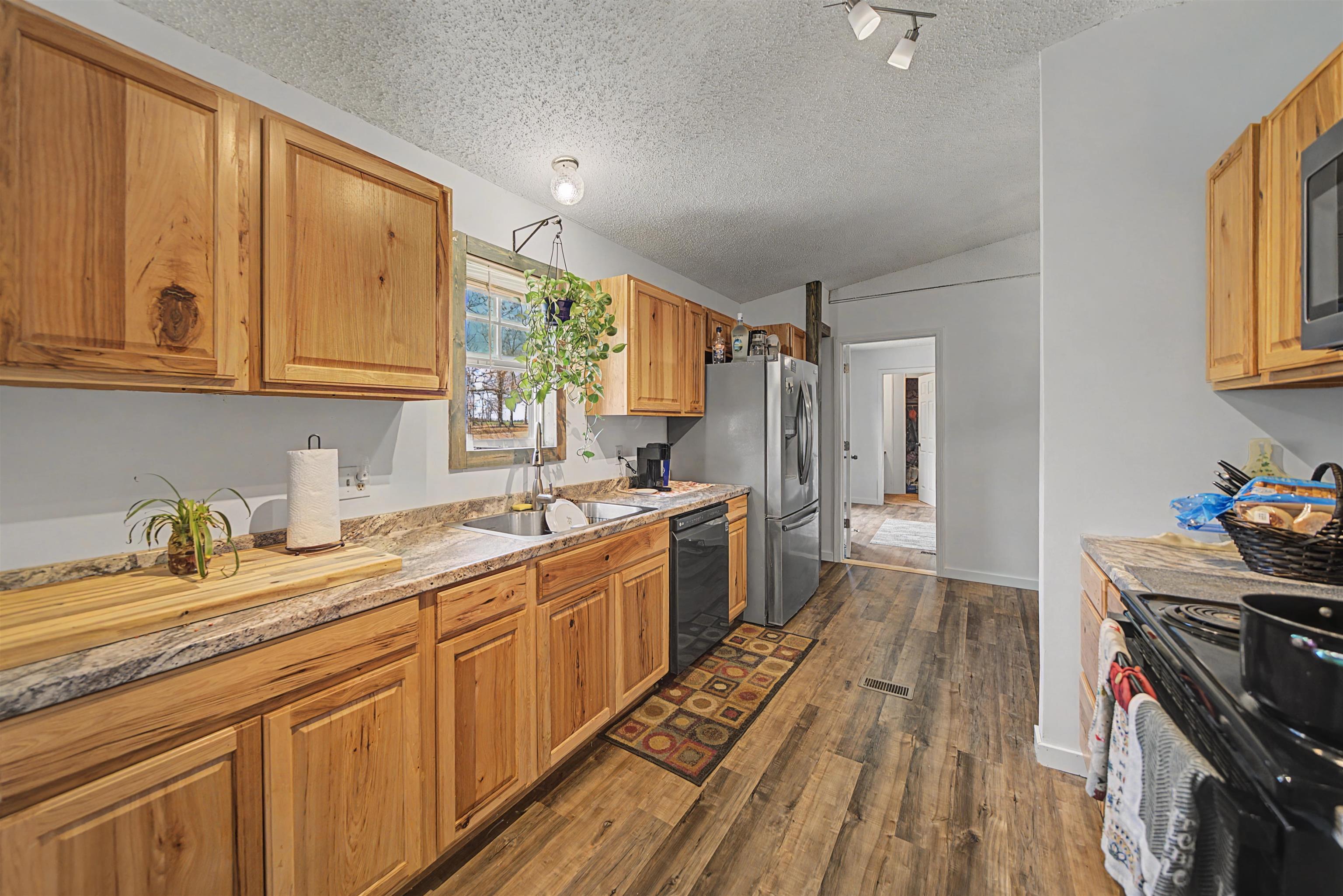 7010 22nd Highway Adamsville, TN 38310 - Photo 7 of 33 a kitchen with a sink stove and cabinets