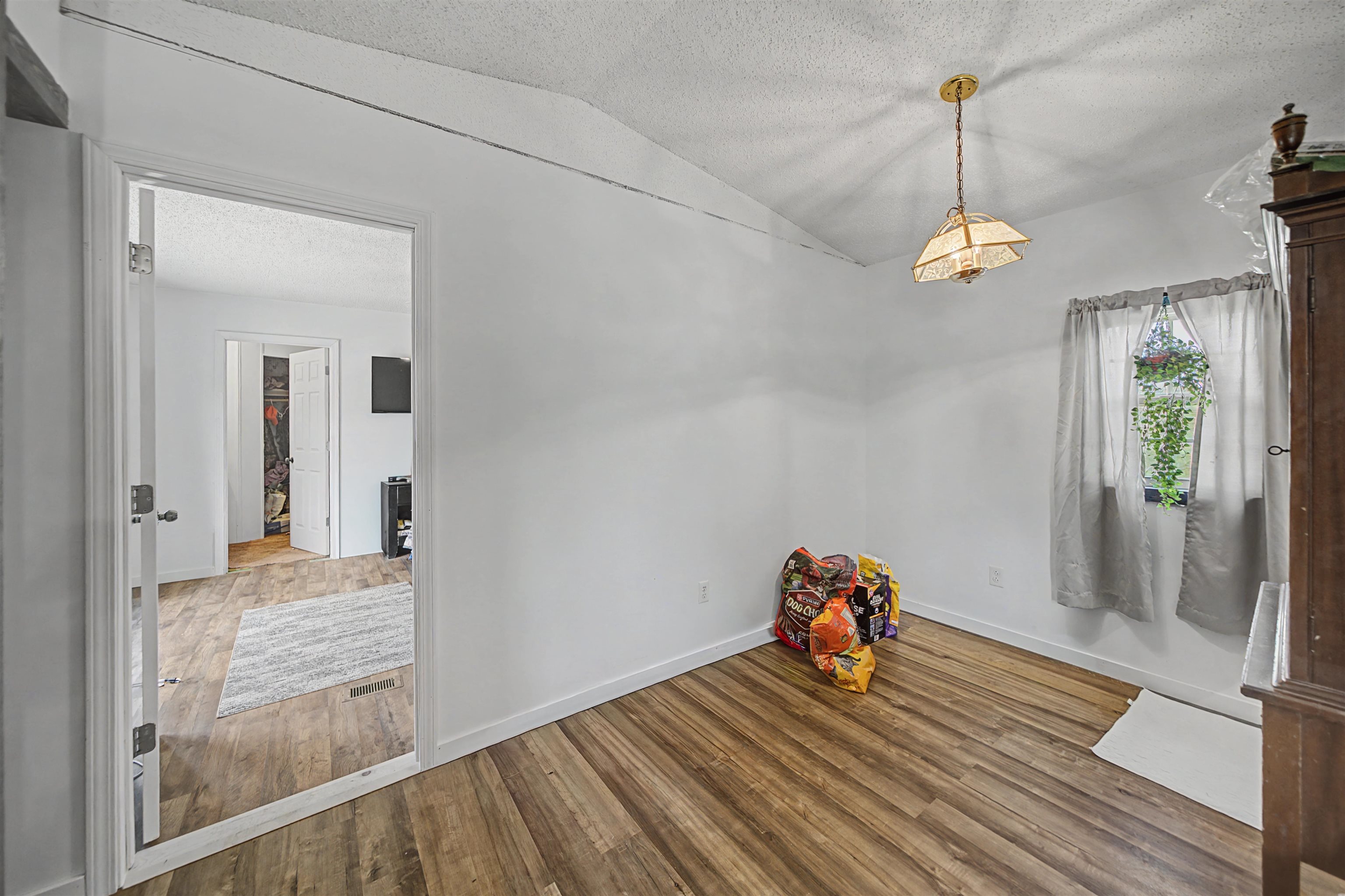7010 22nd Highway Adamsville, TN 38310 - Photo 9 of 33 a view of a livingroom with wooden floor and chandelier