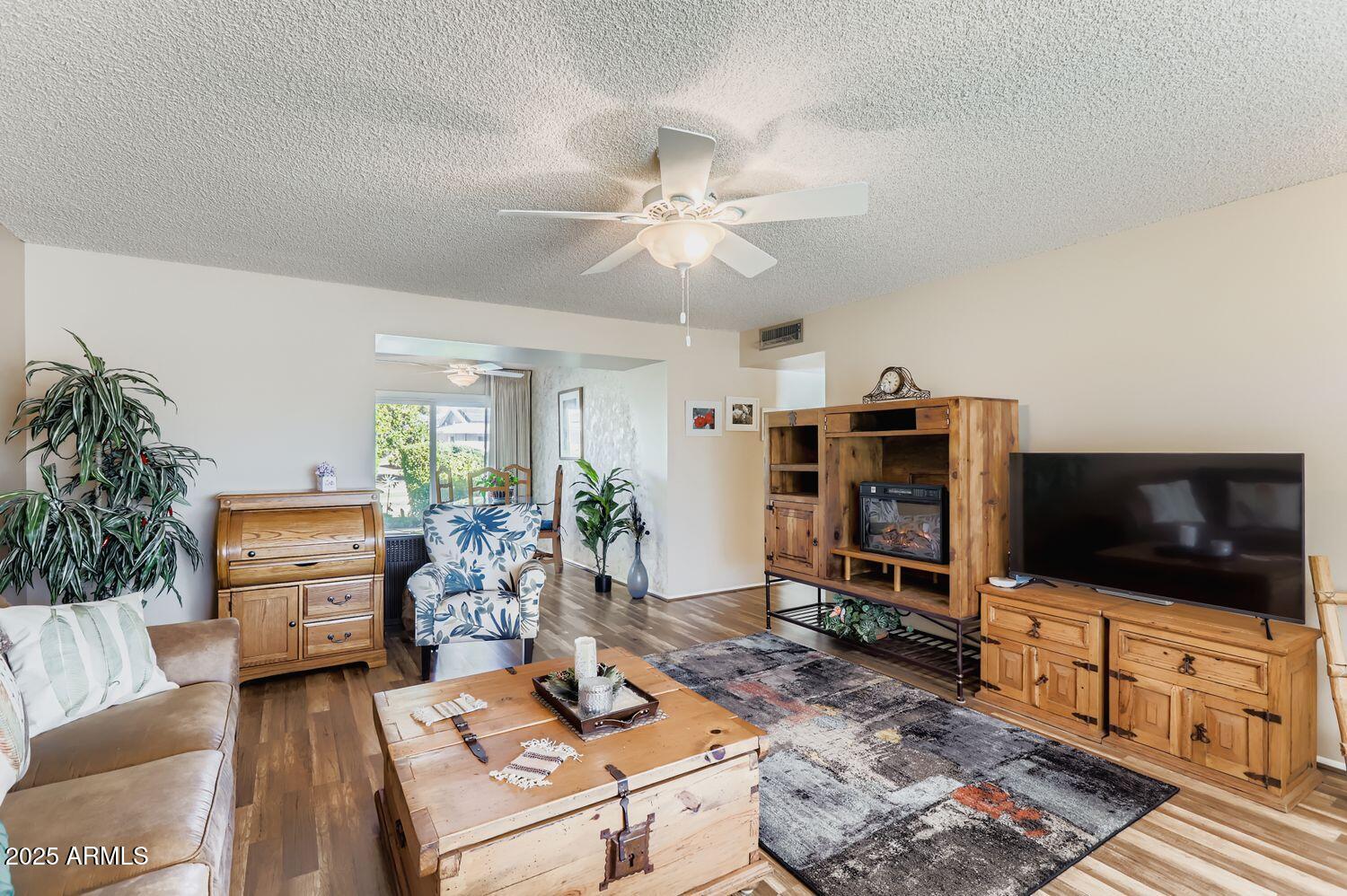 9524 West Greenway Road Sun City, AZ 85351 - Photo 11 of 25 a living room with furniture and a flat screen tv