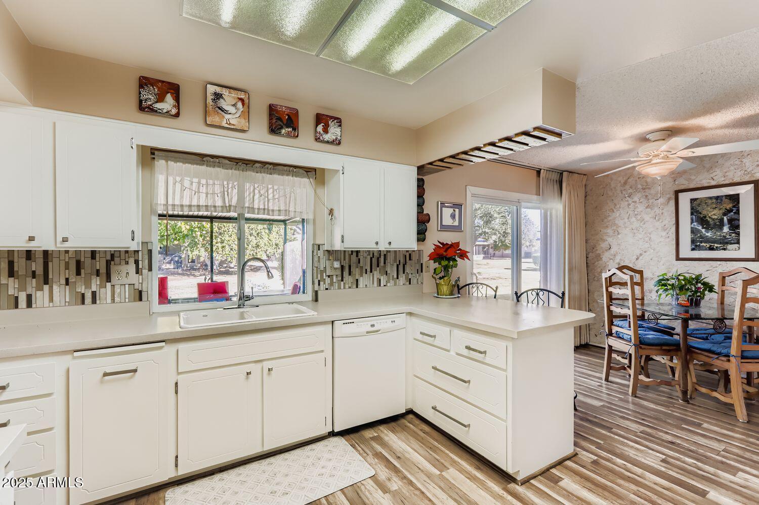 9524 West Greenway Road Sun City, AZ 85351 - Photo 13 of 25 a kitchen with cabinets a sink and appliances