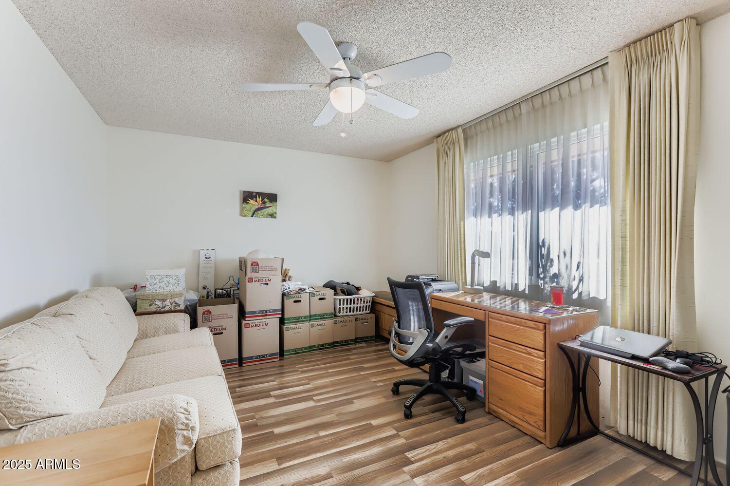 9524 West Greenway Road Sun City, AZ 85351 - Photo 20 of 25 a living room with furniture and a window