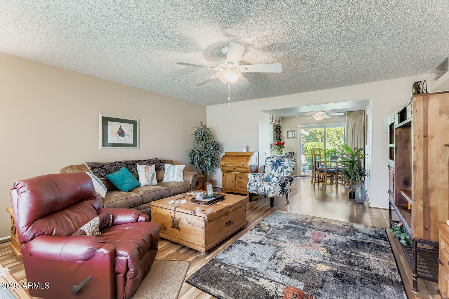 9524 West Greenway Road Sun City, AZ 85351 - Photo 5 of 25 a living room with furniture and a flat screen tv