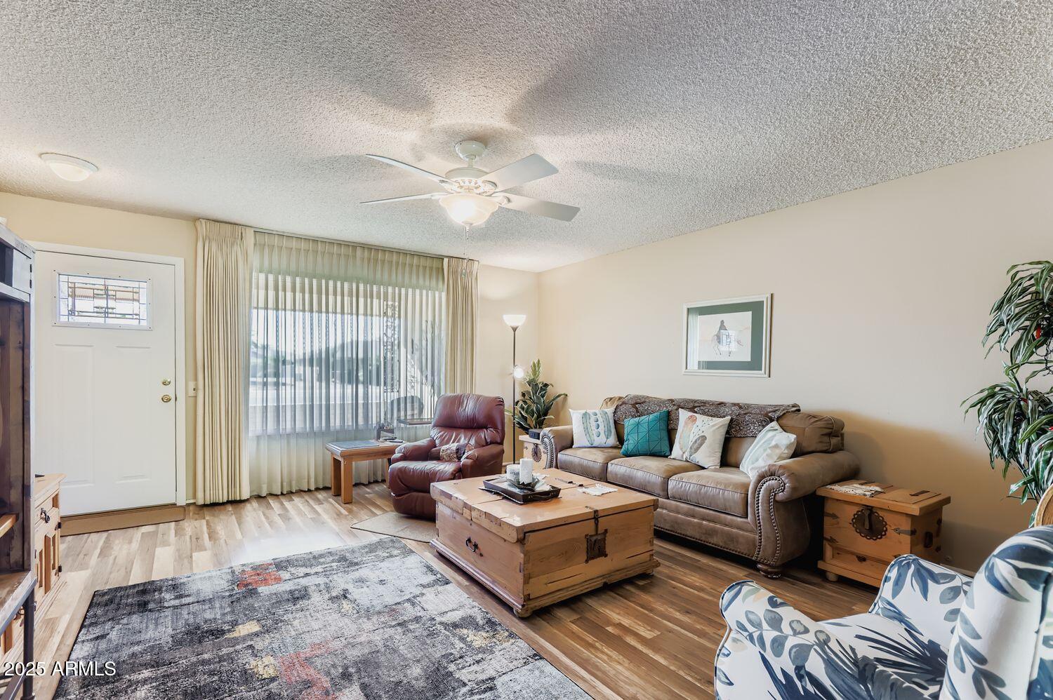 9524 West Greenway Road Sun City, AZ 85351 - Photo 10 of 25 a living room with furniture and a large window