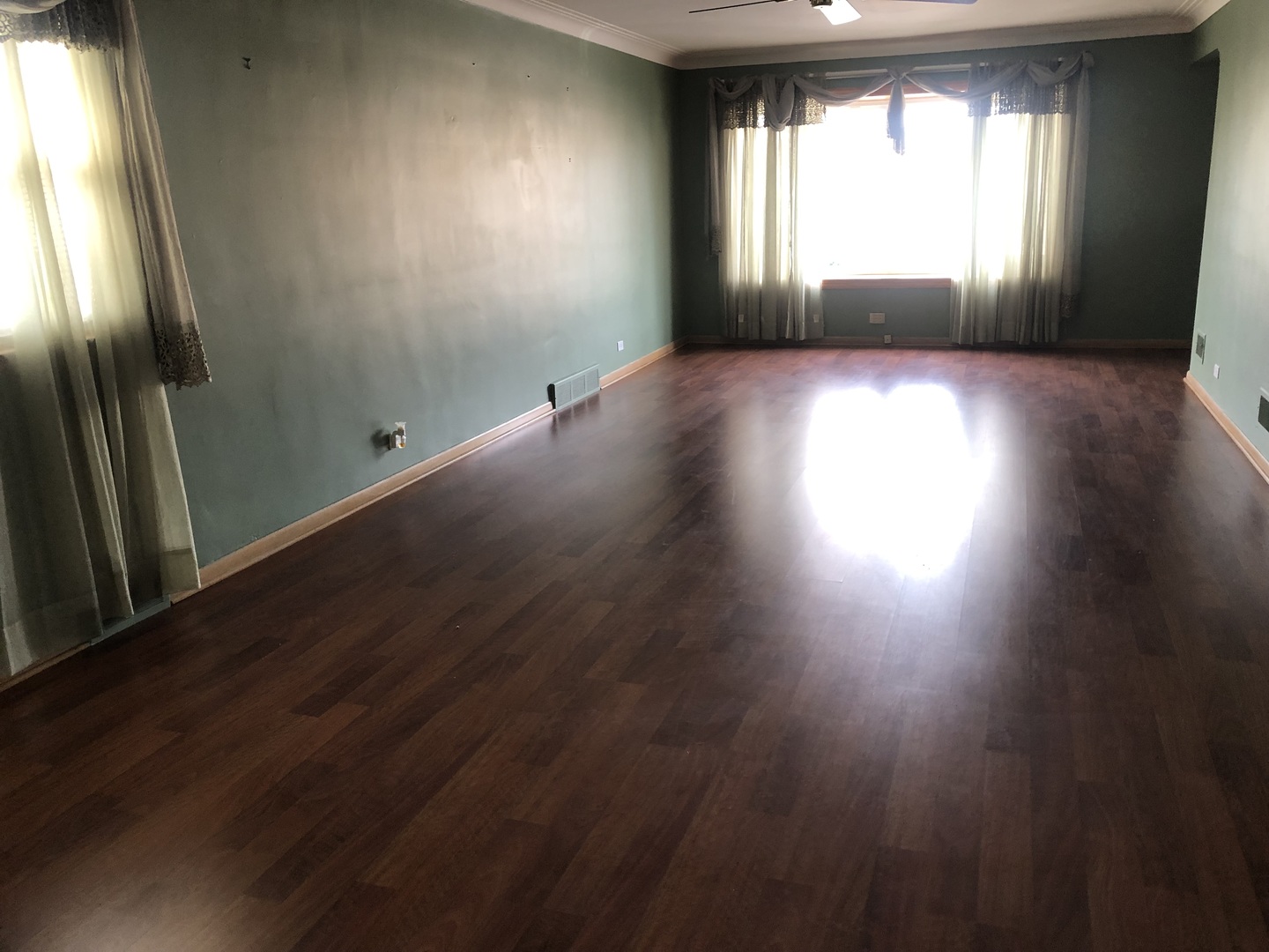 10733 South Harding Avenue Chicago, IL 60655 - Photo 4 of 20 an empty room with wooden floor and windows