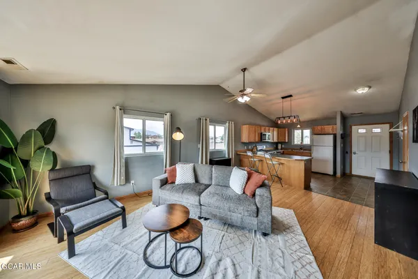 a living room with furniture and kitchen view