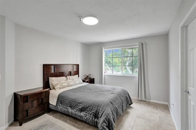 a bedroom with a bed and a lamp