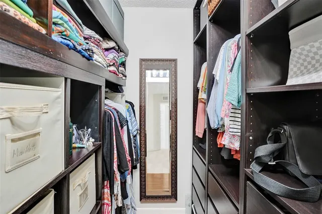 a bedroom with a bed and a night stand