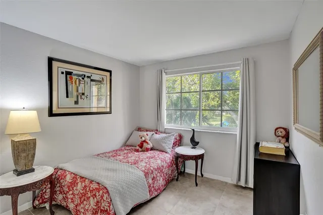 a bedroom with a bed and a lamp