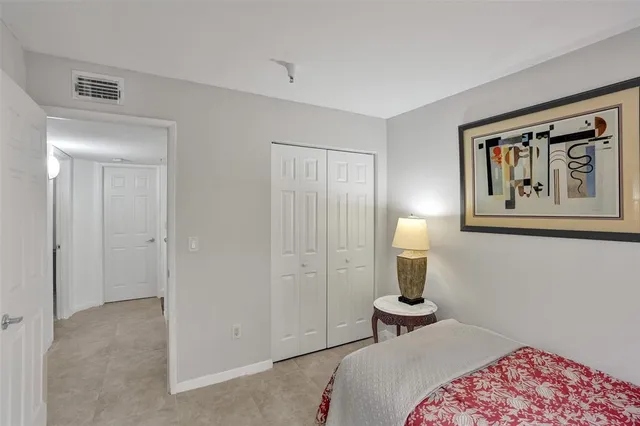 a bathroom with a granite countertop sink and a toilet