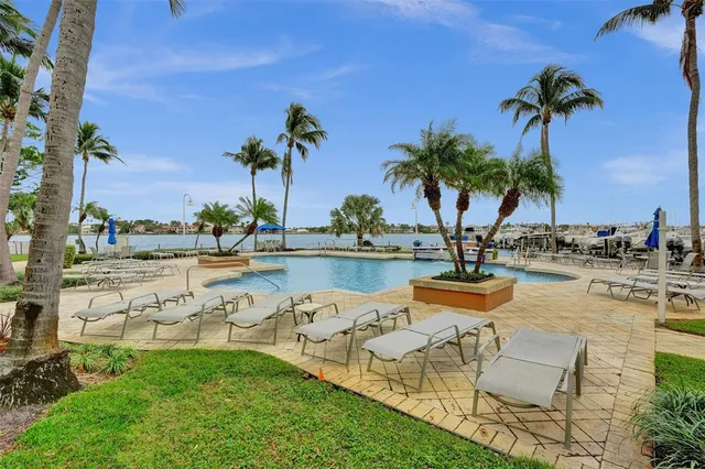 a view of a porch with a table and chairs under an umbrella