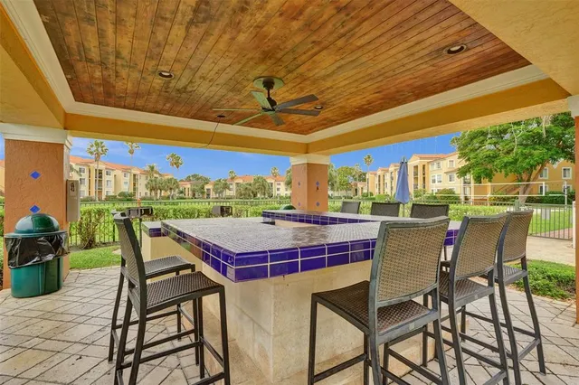 a living room with furniture a projector and screen