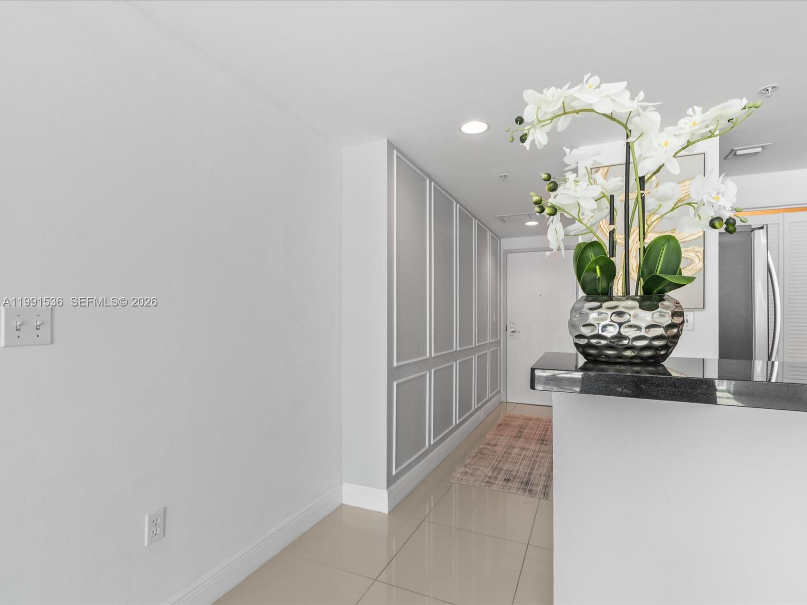 244 Biscayne Boulevard, Unit 1605 Miami, FL 33132 - Photo 16 of 46 a living room with furniture and a chandelier